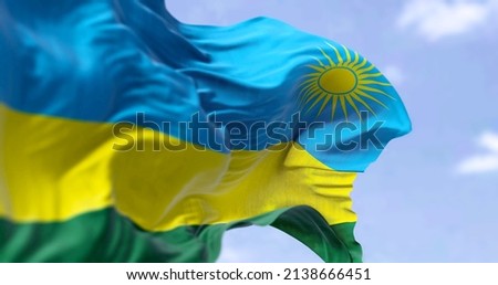 Detail of the national flag of Rwanda waving in the wind on a clear day. Rwanda is a landlocked country in the East Africa. Selective focus. 商業照片 © 