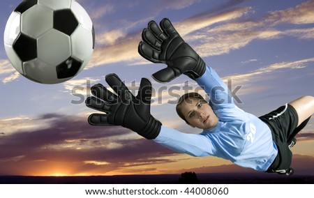 Soccer Goalie leaps for the ball to block