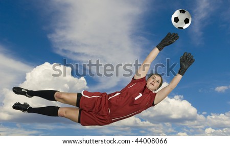 Soccer Goalie leaps for the ball to block