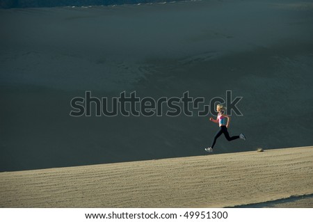 Woman runner on sand dunes