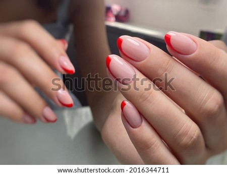 red French nails polishing nails with gel polish, manicure on hands, neat hands, beautiful nails on hands, beauty salon , nail bar