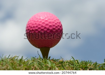 Pink Lady golf ball on a tee