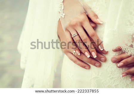 Hands and rings on the wedding dress. wedding theme background