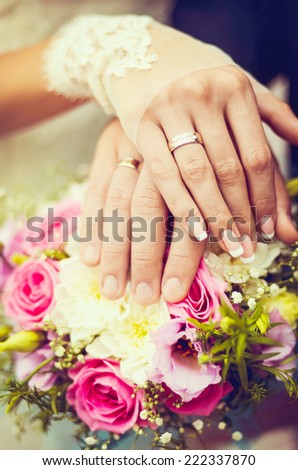 Hands and rings on wedding bouquet. wedding theme background