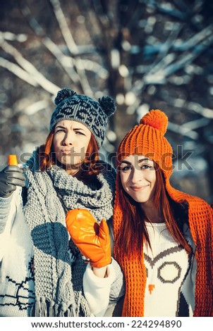 Young beautiful girls friends are in the winter forest. winter theme