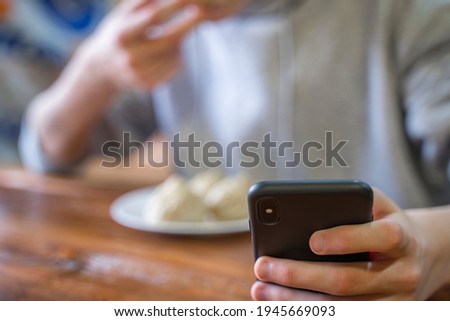 Image, Stock Photo Уoung man, teenager using social networks and phone, teen checking social media holding smartphone at home, young man using mobile phone app playing game, shopping online, ordering delivery while eating