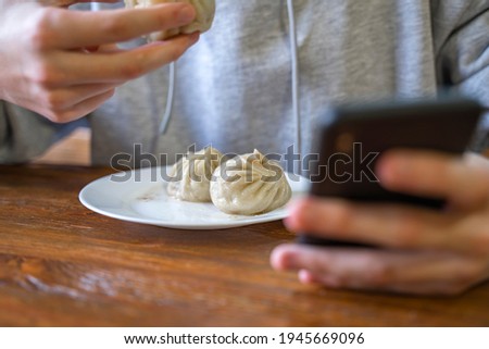 Similar – Image, Stock Photo Уoung man, teenager using social networks and phone, teen checking social media holding smartphone at home, young man using mobile phone app playing game, shopping online, ordering delivery while eating