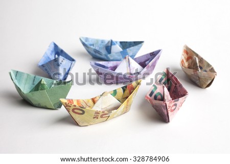 Brazilian bills folded to sailboats. Origami art. Money from Brazil.