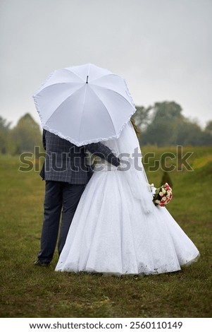 Similar – Image, Stock Photo Happy newlywed couple standing against waving sea