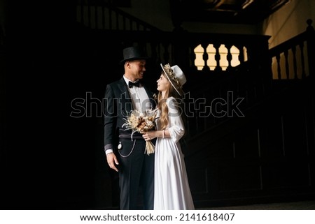 Happy young couple. Brides in hats. Young girl in a white wedding dress and hat with a bouquet of flowers. Brides in the castle. Bride and groom. Photo stock © 