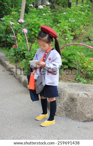 Tokyo, Japan - May 29, 2013: Japanese elementary school student is writing down what she learns on her notebook.