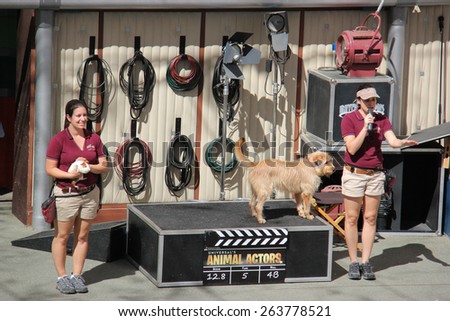 Los Angeles, California, USA - March 12, 2015: The trainer and trained animals are performing in Animal Show at Universal Studios Hollywood.