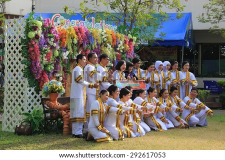 Nonthaburi, Thailand - May 6, 2015: Graduates in graduation gown are taking photos together at their university for the graduation ceremony.