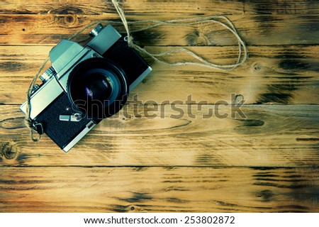Vintage camera on wooden background.Vintage tone.