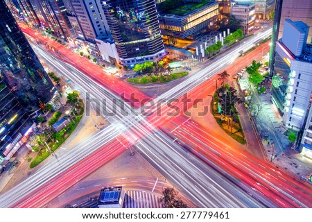 Korea night view . Night traffic speeds through an intersection in the Gangnam district of Seoul,Korea.