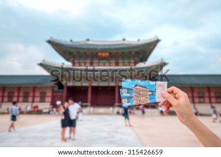 SEOUL, SOUTH KOREA - AUGUST 17: Admission ticket for visit Gyeongbokgung Palace in a hand of female visitor on August 17, 2015 in Seoul, South Korea.