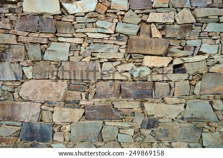 Old schist wall in an European rural area. Backgrounds and textures