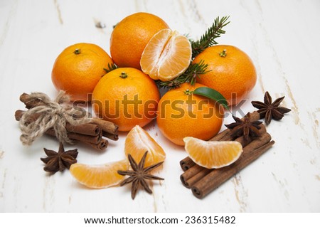 Christmas composition with fresh mandarin oranges, cinnamon, anise on old wooden background
