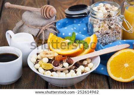 Healthy breakfast of oatmeal,coffee,fresh juice,honey and oranges on a wooden background
