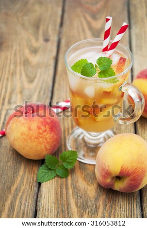 A refreshing cold drink with peach on a wooden table