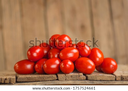 Fresh aromatic plum tomatoes. Plum organic tomatos on market. Italian plum tomatoes. Young juicy tomatoes. Farm market tray full of tomatoes.