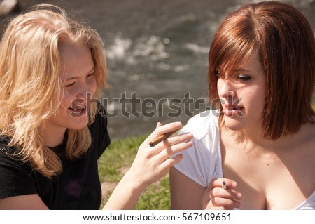 Similar – Foto Bild Teenager-Mädchen mit Rauchzeichen am Strand