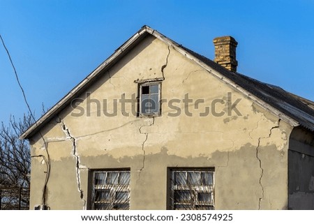 Similar – Foto Bild Alt | Hausfassade mit blätterndem Putz, mit blauen Planen statt Fenstern und einer Lampe