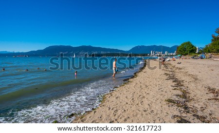 VANCOUVER, BC/CANADA - JULY 30: People enjoying the day at the Kitsilano beach in Vancouver, Canada on July 30, 2015. Kitsilano Beach is one of the most popular beaches in Vancouver.