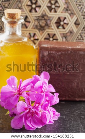 Brown soap, flower and oil over hammam background