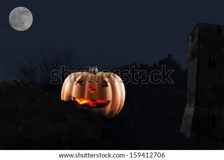 Jack-o-lantern behind a wall in a night scene