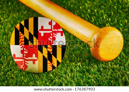 Baseball with Maryland flag and bat over a background of green grass