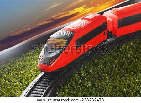 Small train under sunset light, over green grass Stok fotoğraf © 