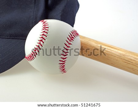 A baseball near a bat and a blue hat