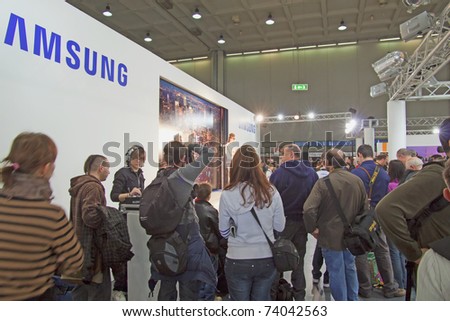 MILAN, ITALY - MARCH 27: People shooting a model in Samsung stand at international photographic Fair 