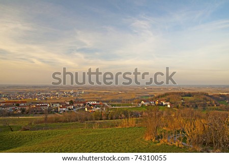 Cloudy sky on the land, with town and fields