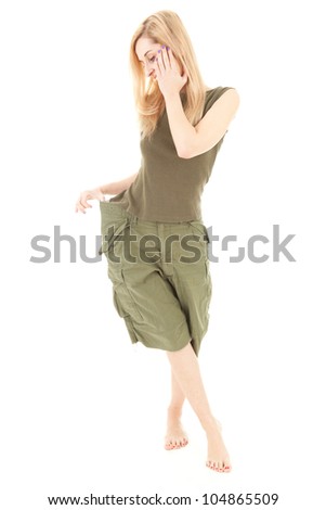 weight lost - I can't stop thinning, young woman in too big green trousers, full length, white background