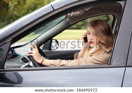 smoking young businesswoman  driving a car and speaking on the phone
