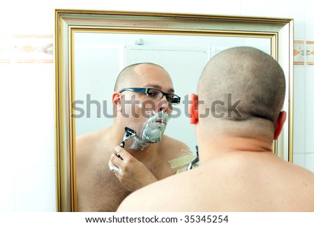 shaving man in glasses