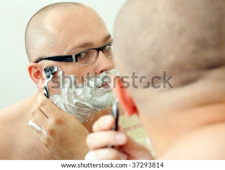 shaving man in glasses
