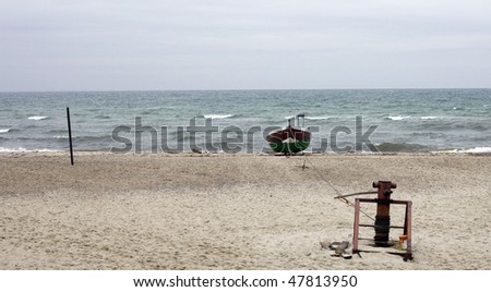 moored boat on beach  of calm sea