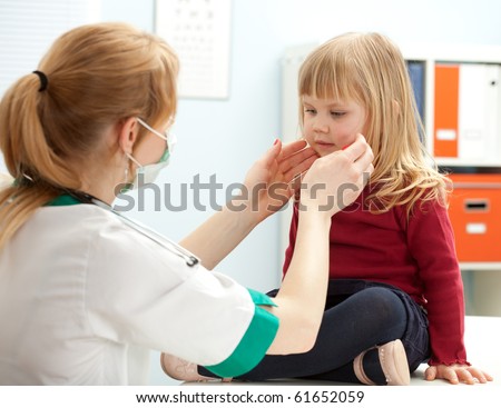 female doctor examining little girl in exam room