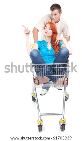 couple - man thrusting shop trolley, woman pointing