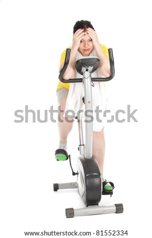 tired overweight, fat woman in yellow shirt on stationary fitness bicycle, series