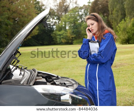 woman car mechanic repairs engine damaged car, trouble with the car engine in the road, series