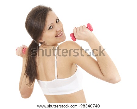exercising young woman in sports bra working out in the gym and curling with small dumbbells