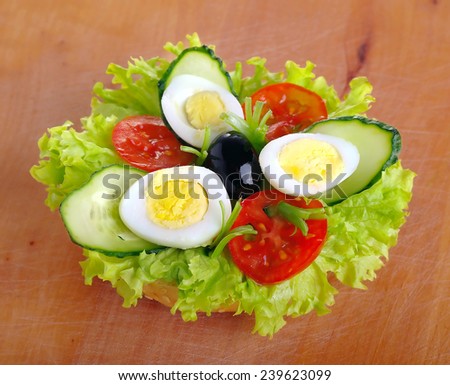 Fresh egg-cucumber sandwich on a wooden board - close up