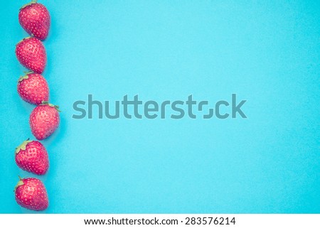 Some strawberries in line with a lot of copy space for your text or editing.
