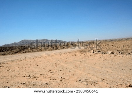 Similar – Image, Stock Photo Distant traveler on rocky formation in sea