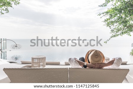 Relaxation holiday vacation of businessman take it easy happily resting on beach chair at swimming pool poolside beachfront resort hotel peacefully with sea or ocean view and summer sunny sky outdoor ストックフォト © 