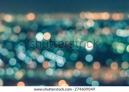 Blurred abstract background of bokeh lights city night shots from bird eye view in vintage color tone : Vintage color tone blurry colorful bokeh lights of night cityscape